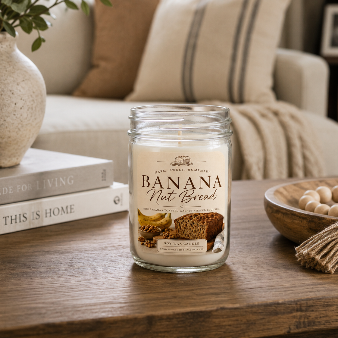 Banana Nut Bread candle on a wooden table with a cozy living room background